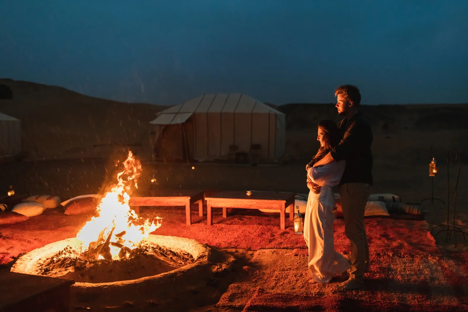 couple hub in love near big campfire romantice in desert — best Morocco tours