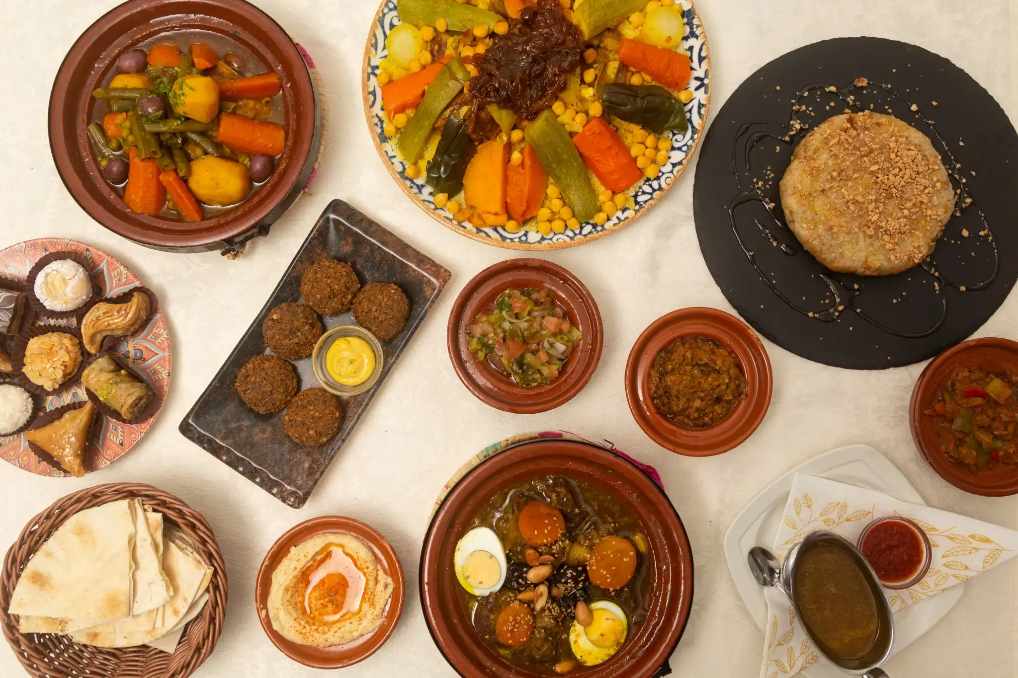 Hands preparing a Moroccan tagine at a cooking class in a riad