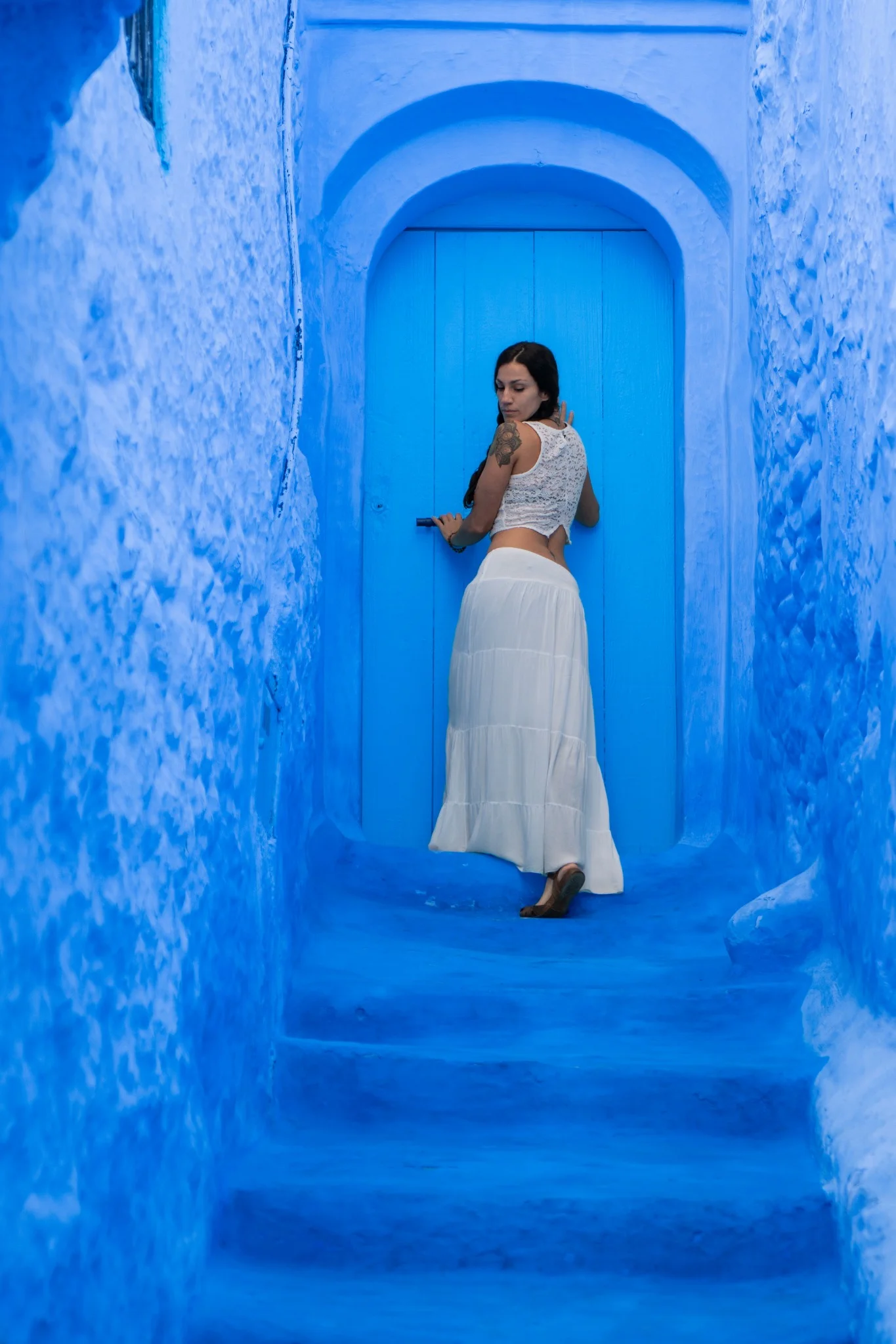 Women walking through the blue streets of Chefchaouen, Morocco
