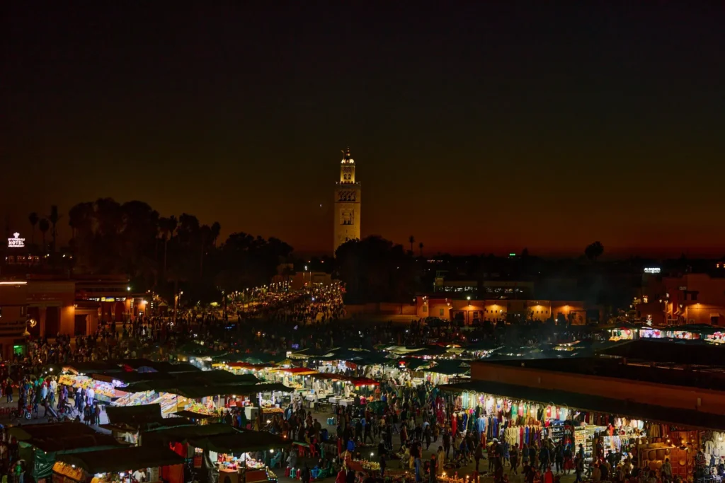 All Morocco Tours —Jemaa el-Fnaa square at dusk with the Koutoubia minaret, Marrakech