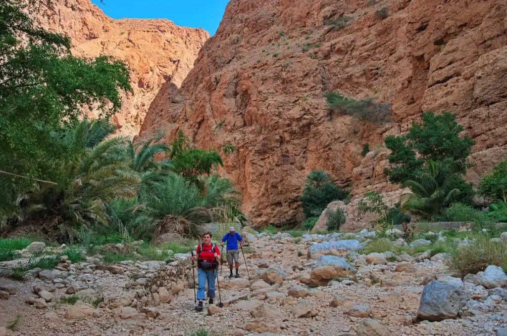 All Morocco Tours —hikers on a High Atlas trail above a Berber village