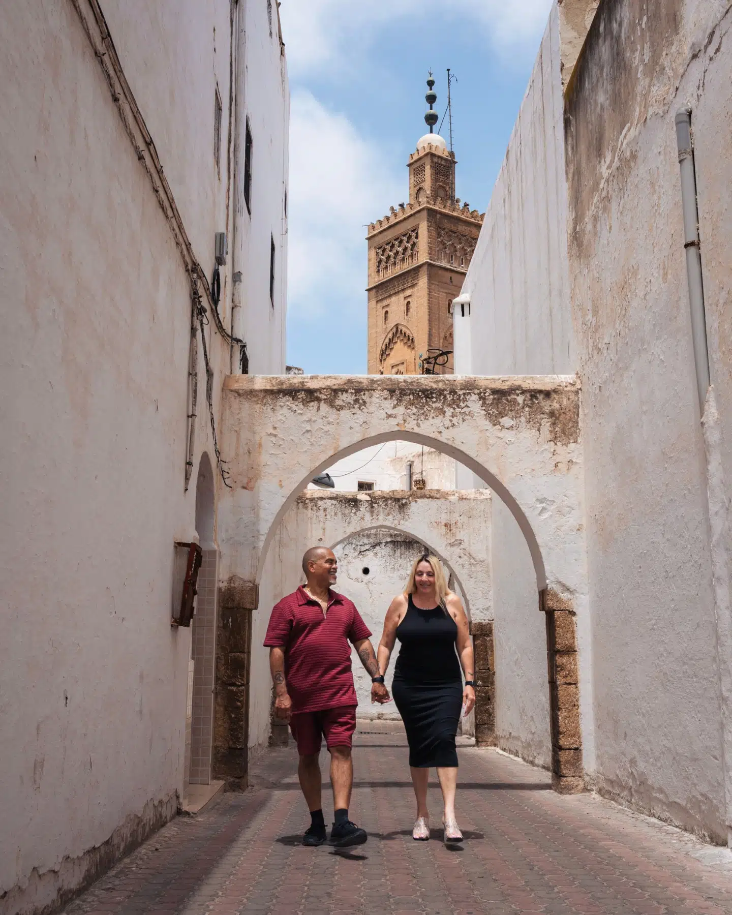 Historic palace courtyard in Morocco with green arched windows and a central fountain